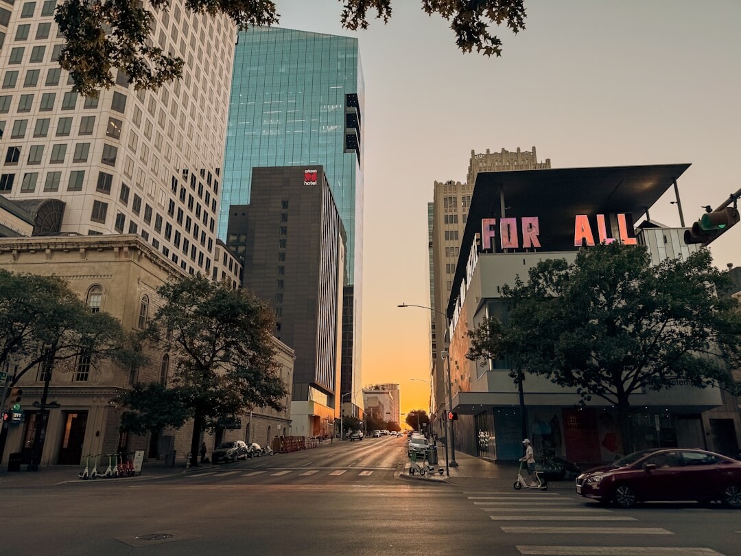 Pedestrians crossing a city street at golden hour