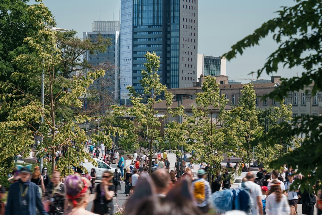 Crowd of people crossing a busy plaza in a city center