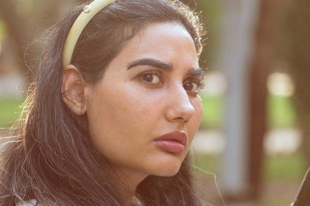 Latina woman with a calm expression looking sideways